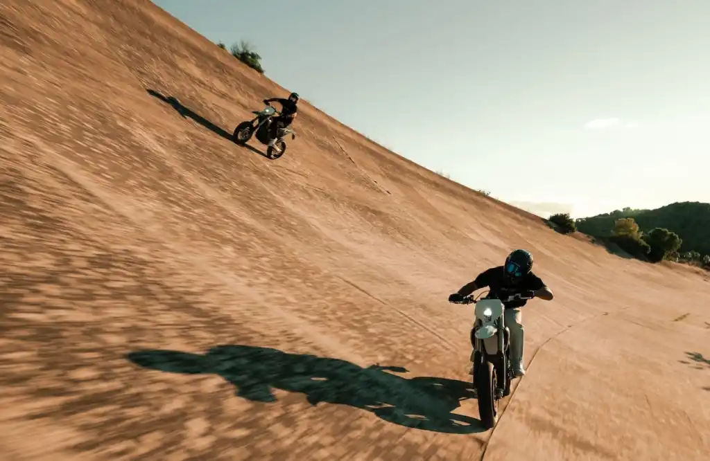 Dynamic shot showing rider attacking corner with knee out or foot out supermoto style